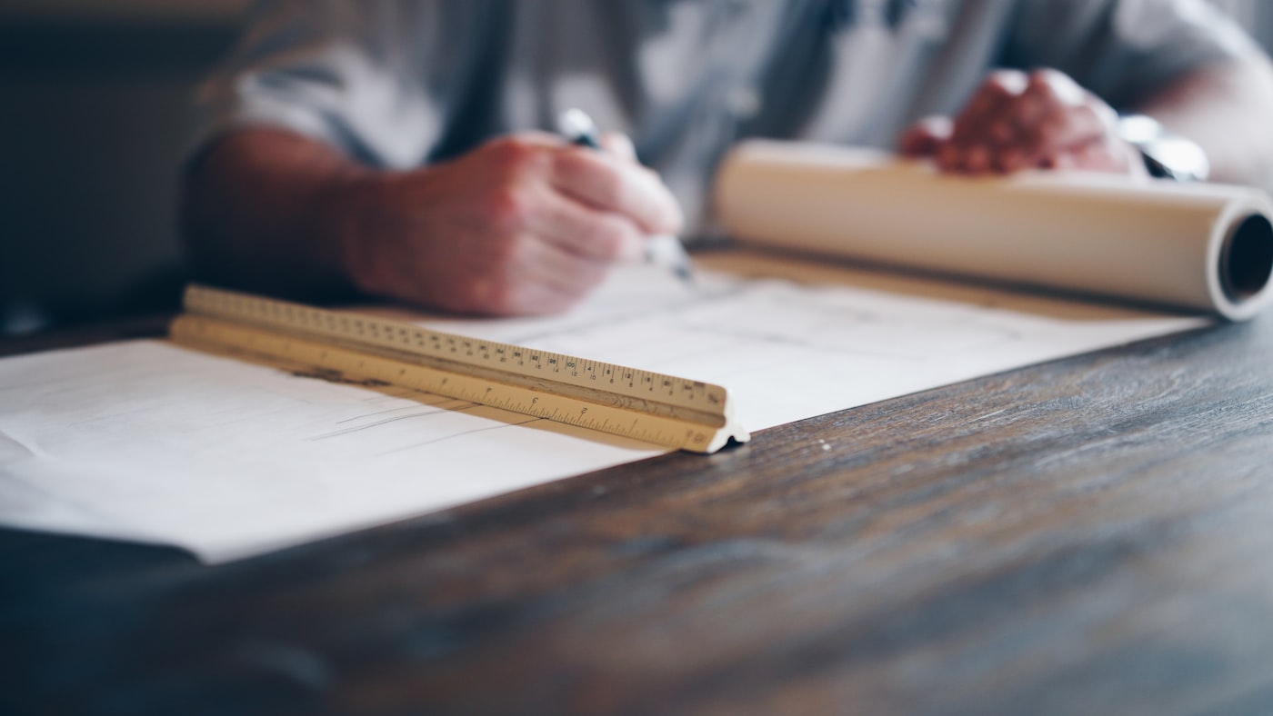 Architectural floor plans and blueprints on a work surface
