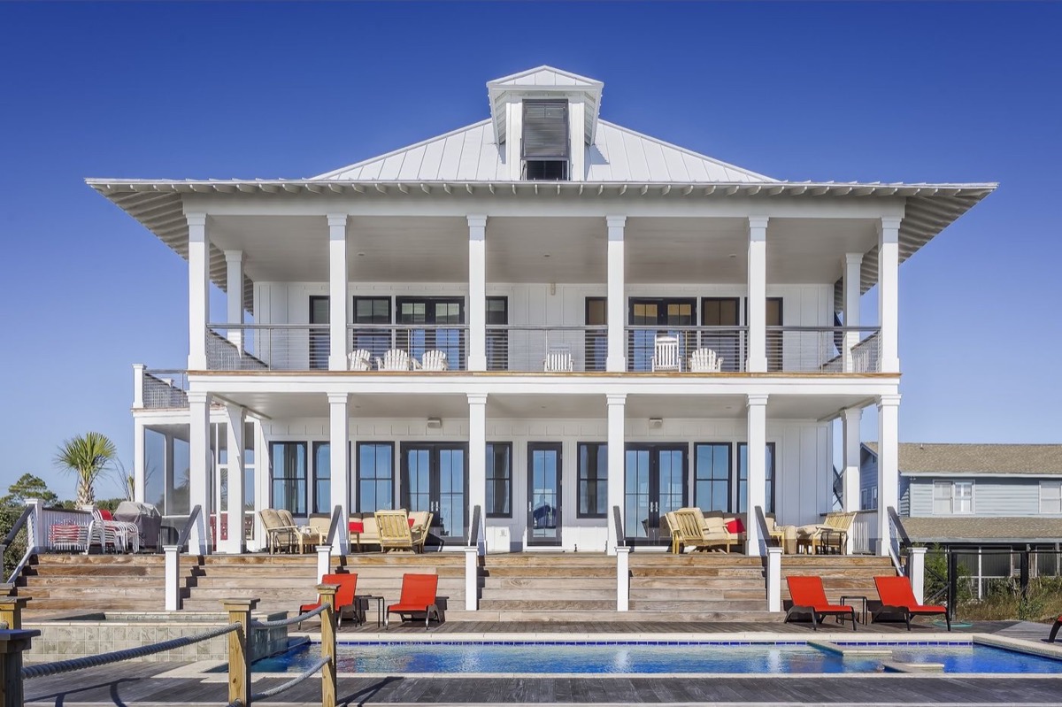 Classic white beach house with pool and dual porches
